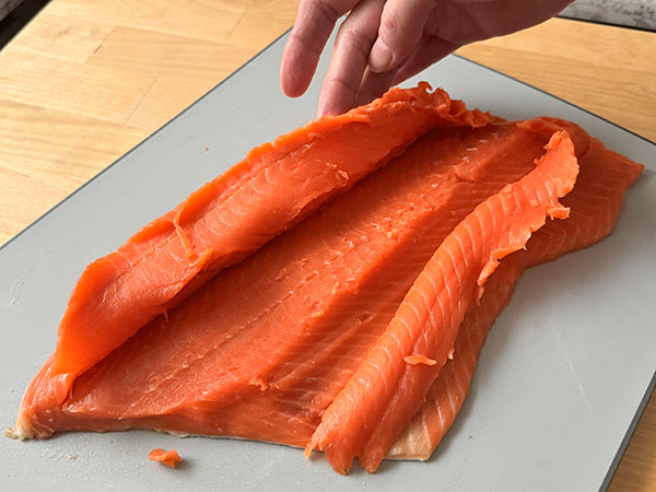 Raw wild salmon filet with a cut out pocket for filling.