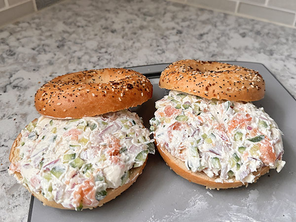 Fresh toasted everything bagels topped with homemade salmon, cream cheese, cucumber and onion spread.