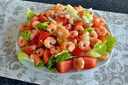 Combined ingredients for Shrimp Salad with Lettuce and Tomatoes.