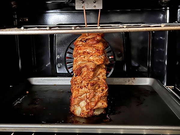 Shawarma chicken tower baking in the oven.