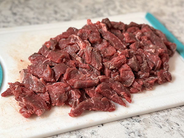 Top sirloin steak sliced into thin strips for beef shawarma.